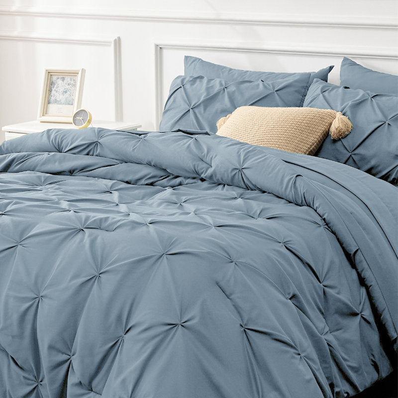 Blue textured comforter set on a bed 