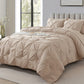 Beige comforter set on a bed in a bedroom with a large window.