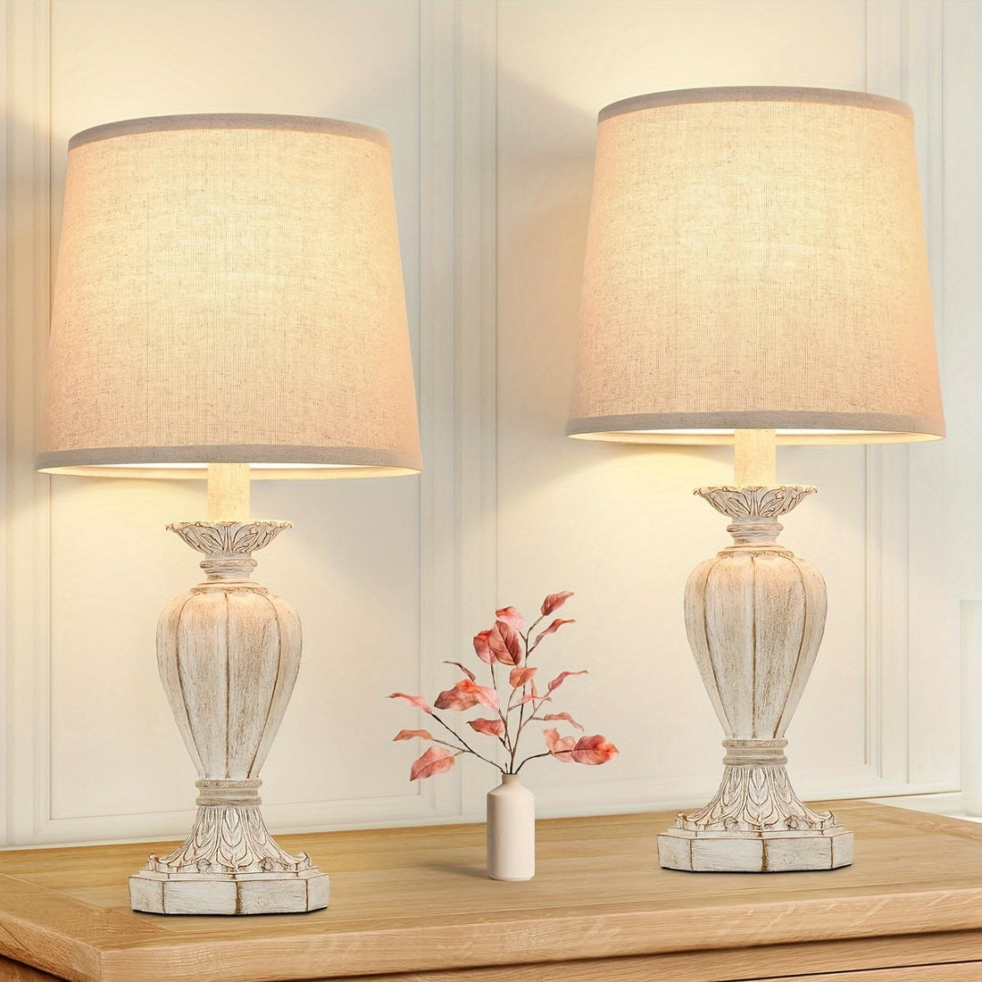 Two decorative table lamps with beige lampshades on a wooden surface.