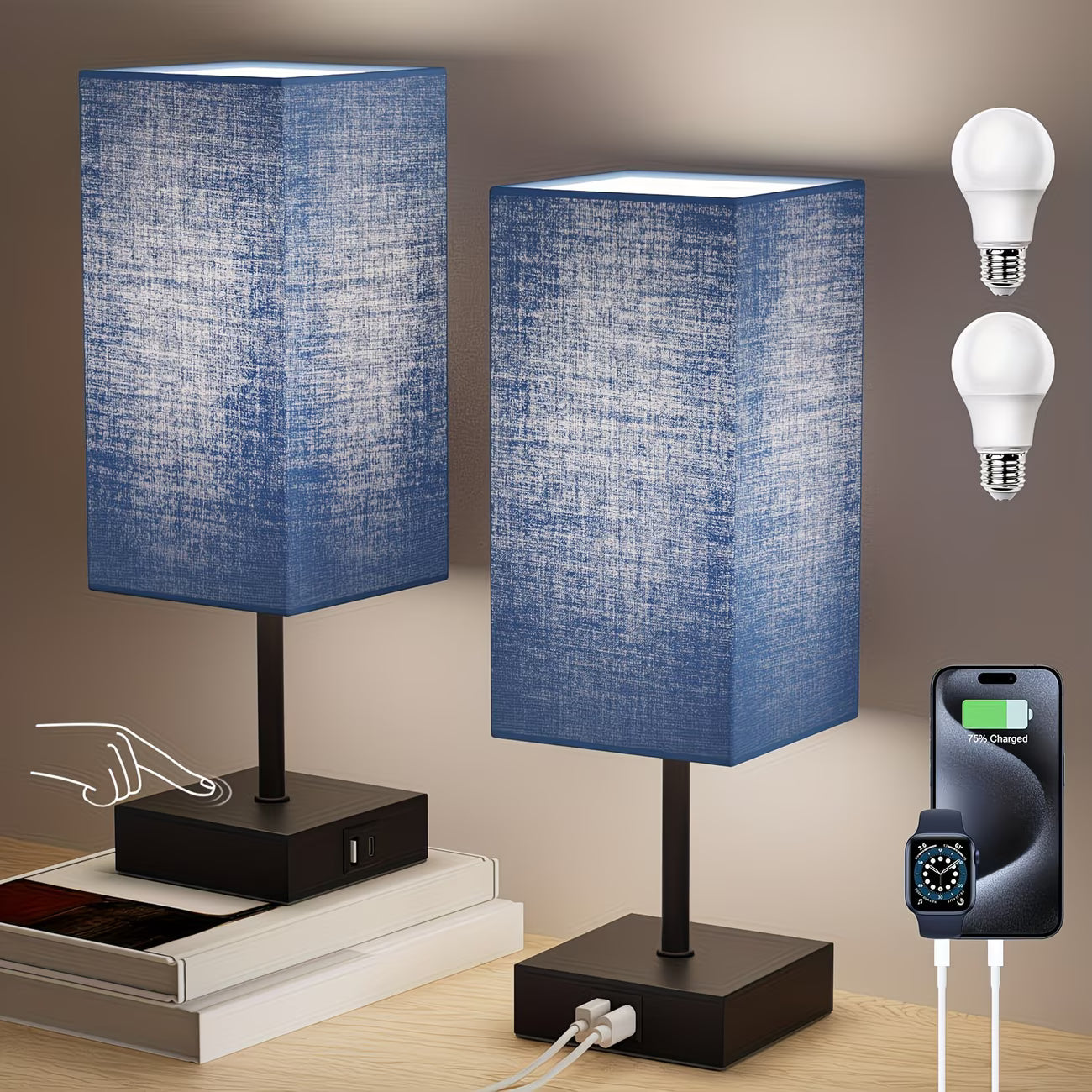 Two blue table lamps with power outlets on a wooden surface, with light bulbs and a smartphone charging device shown.