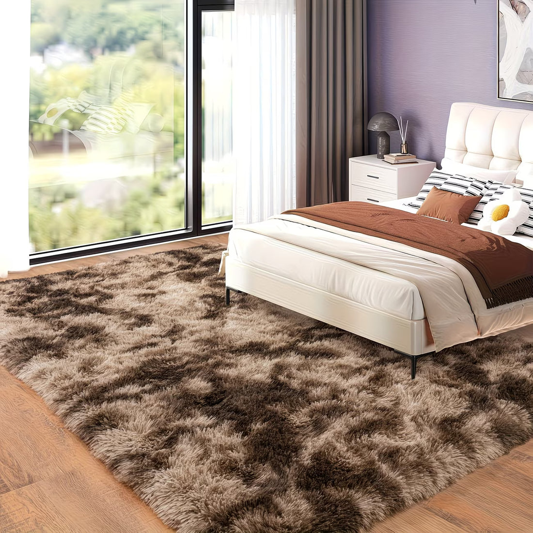 Modern bedroom with a fluffy brown rug, bed, and large window.