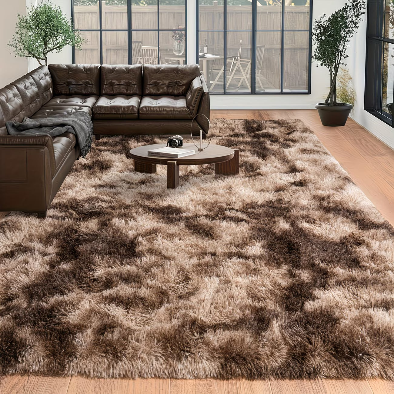 Living room with a brown sectional sofa and a patterned rug.