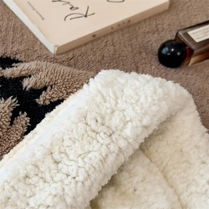 Close-up of a textured white fabric with a book and perfume bottle in the background.