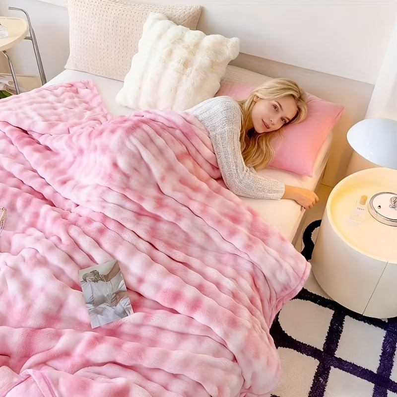 Woman lying in bed under a pink blanket with a nightlight on a nightstand.