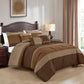 Bedroom with brown and beige comforter set on a bed, lamp, and framed artwork.
