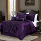 Purple damask bedding set on a bed in a bedroom with a lamp and decor.