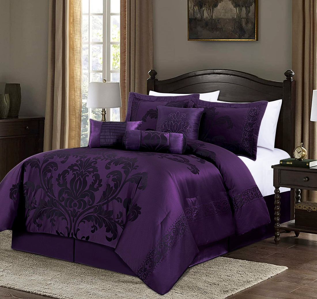 Purple damask bedding set on a bed in a bedroom with a lamp and decor.