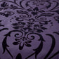 Black floral pattern on a purple fabric background