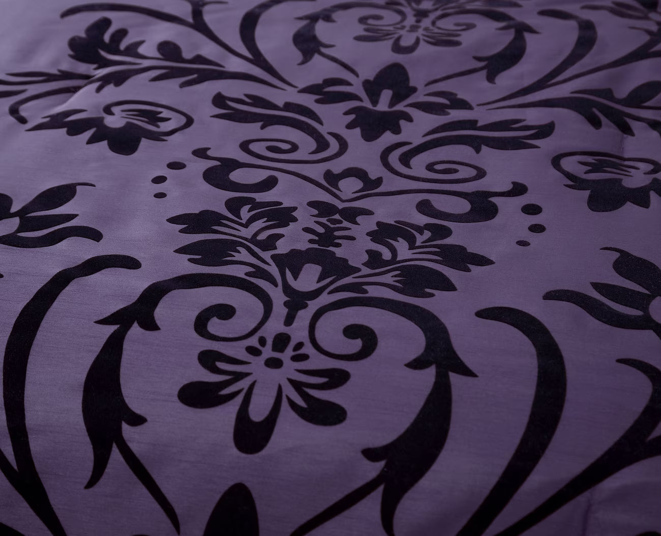 Black floral pattern on a purple fabric background