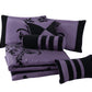 Purple and black bedding set with decorative pillows on a white background