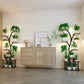 Modern interior with wooden cabinet and plant shelves against a white brick wall.