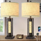 Two table lamps with woven lampshades on a wooden surface.