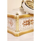Decorative white and gold clock with intricate designs on a white background