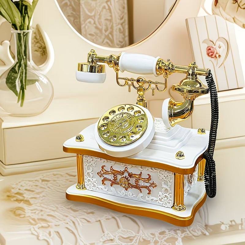 Decorative vintage-style telephone with gold and white design on a decorative surface.