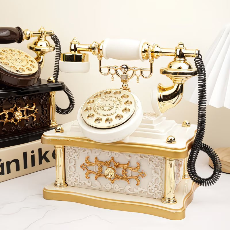 Vintage-style telephone with gold and white design on a light background