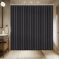 Black shower curtain in a bathroom setting with tiled walls and a sink.