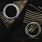 Two metallic rings on a black surface with gold geometric patterns