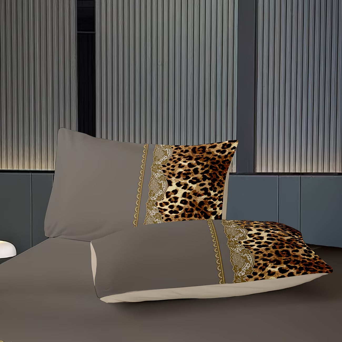 Gray bedding set with leopard print accent pillows on a bed against a striped wall.