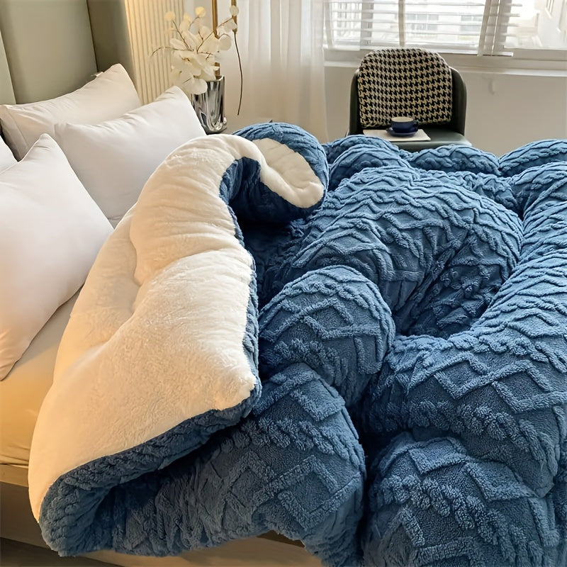 Blue textured blanket draped over a sofa in a living room setting.