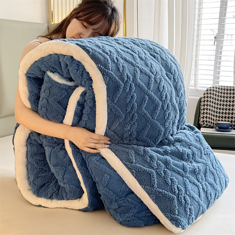 Person hugging a large blue textured blanket indoors.