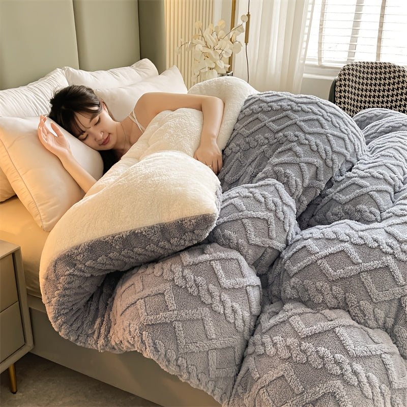 Woman lying on a bed under a gray textured blanket and pillow