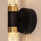 Wall-mounted light fixture with black and gold design on a neutral background