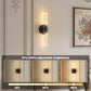 Wall-mounted light fixture with adjustable brightness indicator on a wall with decorative elements.