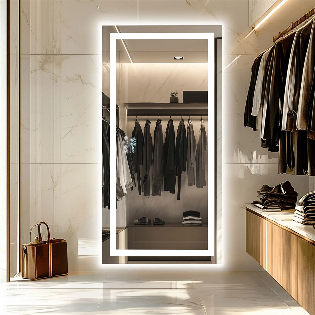 Modern interior with a large illuminated mirror reflecting awardrobe and clothing.