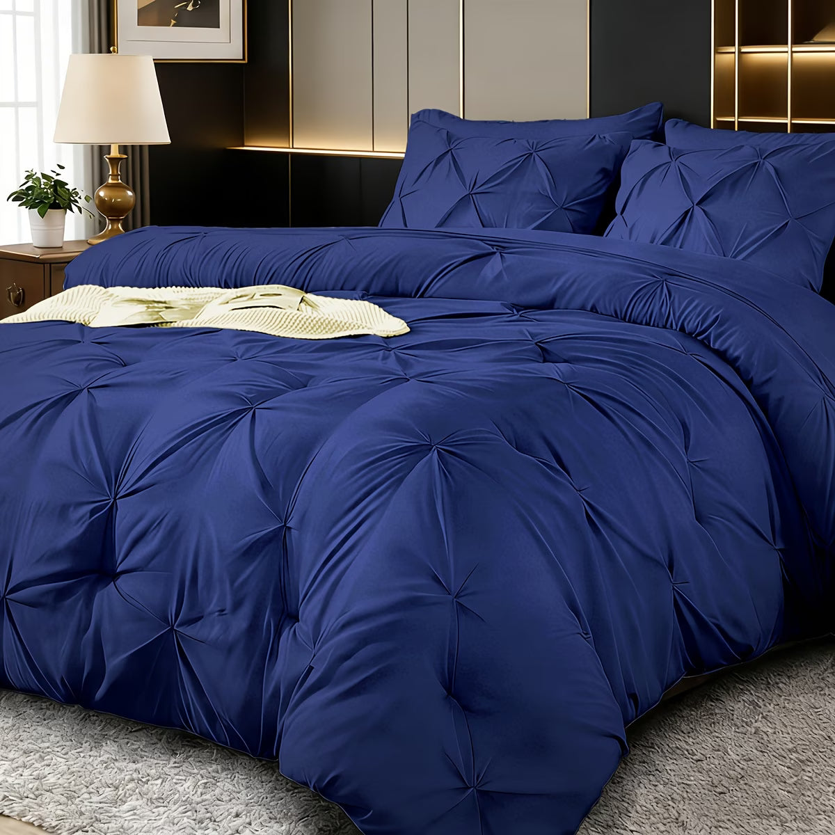 Blue textured comforter set on a bed in a bedroom setting.