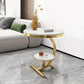 Modern living room with a gold side table and marble top.