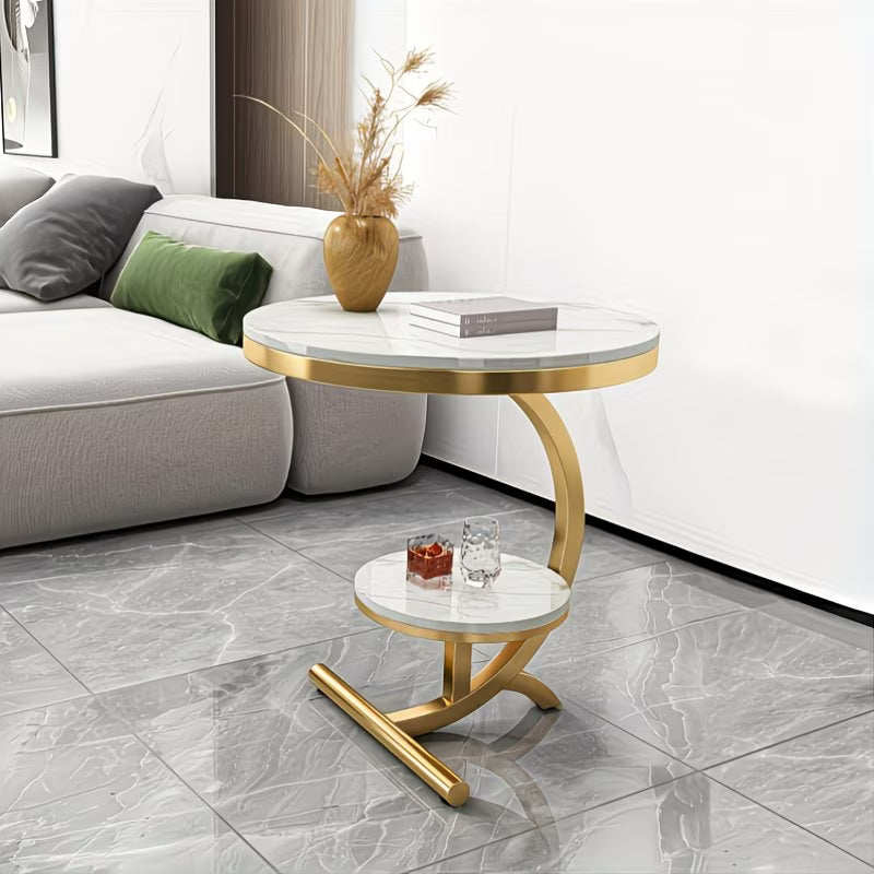Modern living room with a gold side table and marble top.