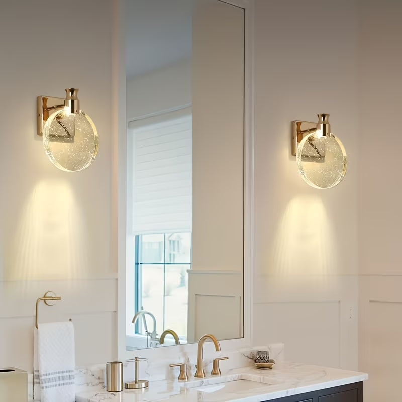 Bathroom with gold wall sconces and a large mirror.