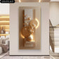Decorative wall art with floral elements and gold accents in a modern interior setting.