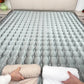 Person unrolling a mattress on a bed