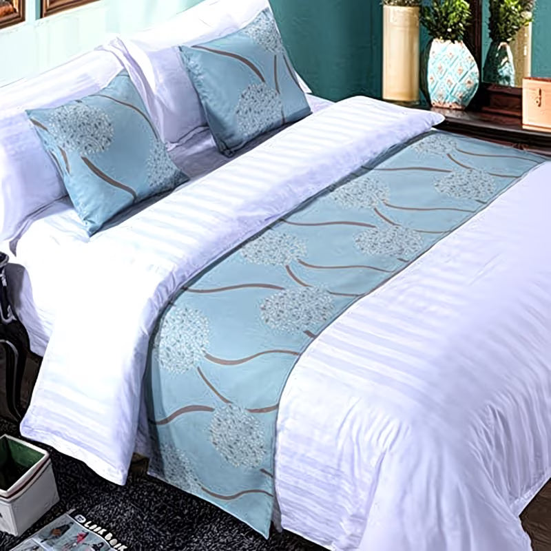 Bed with white bedding and blue decorative runner in a bedroom setting.